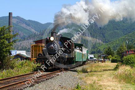 Tourists ride behind a 1910 Heisler Steam Locomotive at Garibaldi, Oregon, USA.