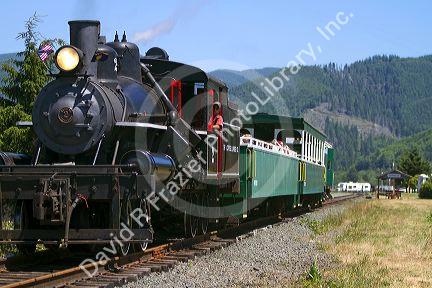 Tourists ride behind a 1910 Heisler Steam Locomotive at Garibaldi, Oregon, USA.