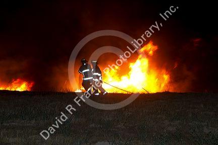 Firefighters work to contain a fire near Federal Way and Kootenai streets in Boise, Idaho, USA. August 21, 2010