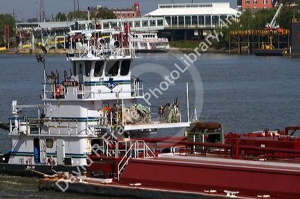 Tug boat and river barge on the Mississippi River at New Orleans, Louisiana, USA.