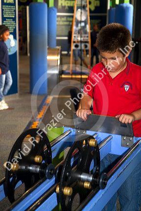 Boy using an interactive exhibit at the Gulf Coast Exploreum Science Center in Mobile, Alabama, USA.