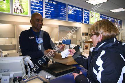 Female customer and male african american postal worker in Boise, Idaho, USA.
