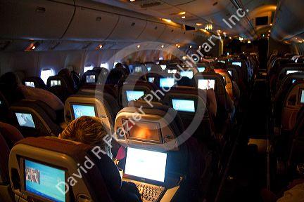 Interior of a Boeing 767 aircraft coach class cabin. 