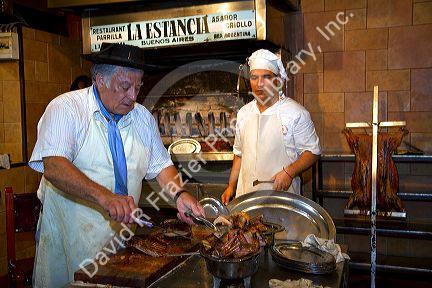 Chefs cooking meat at La Estancia restaurant in Bueos Aires, Argentina.