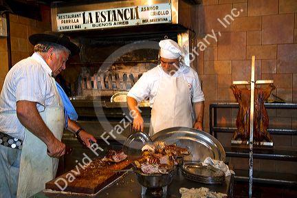 Chefs cooking meat at La Estancia restaurant in Bueos Aires, Argentina.