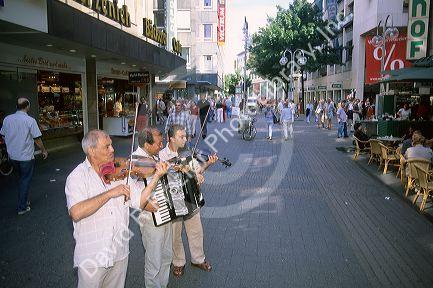 Musicans perform on a walking street in Cologne, Germany.