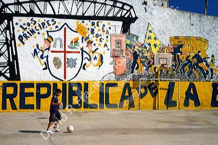 Argentine boy playing soccer in the La Boca barrio of Buenos Aires, Argentina.