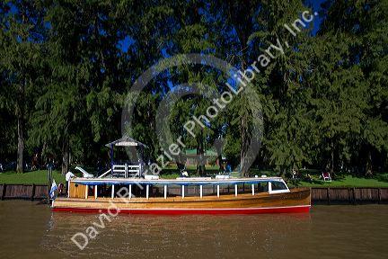 Vintage mohogany motorboat on the Parana Delta at Tigre, Argentina.
