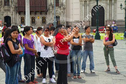 Teacher and students at the Plaza Mayor or Plaza de Armas of Lima, Peru.
