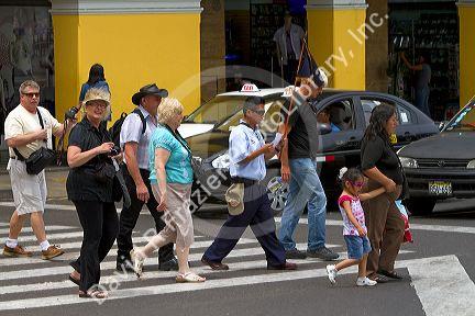 Pedestrians at the Plaza Mayor or Plaza de Armas of Lima, Peru.