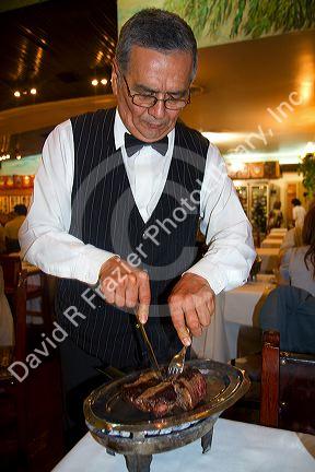 Server at La Estancia restaurant in Bueos Aires, Argentina.