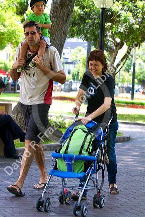 Family walking in Central Park of the Miraflores district of Lima, Peru.