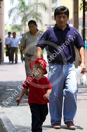 Father and son in Central Park of the Miraflores district of Lima, Peru.