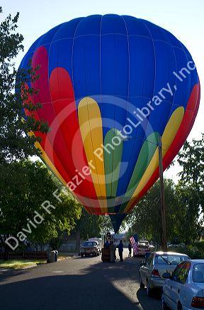 Hot air balloon landing in a residential area of Boise, Idaho, USA.