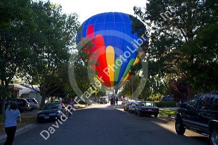 Hot air balloon landing in a residential area of Boise, Idaho, USA.