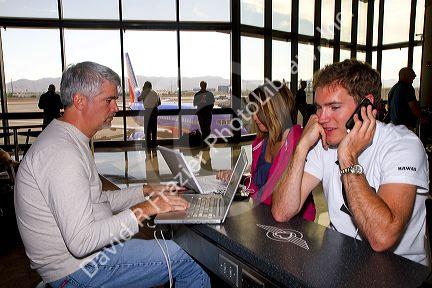 People use wi-fi internet at the Phoenix Sky Harbor International Airport located in the city of Phoenix, Arizona, USA.