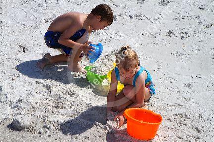 Brother and sister playing at Madeira Beach in Pinellas County, Florida, USA.