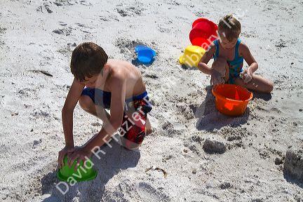 Brother and sister playing at Madeira Beach in Pinellas County, Florida, USA.