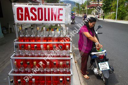 Gasoline being sold in one liter whiskey bottles at Chaweng beach village on the island of Ko Samui, Thailand.