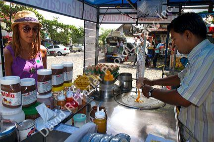 Street food vendors selling flavored pankakes at Chaweng beach village on the island of Ko Samui, Thailand.
