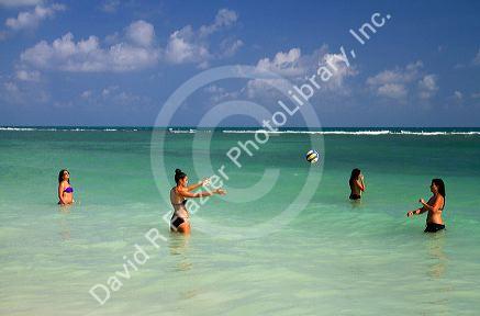 Women play volleyball in the Gulf of Thailand at Chaweng beach on the island of Ko Samui, Thailand.