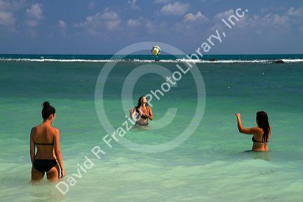 Women play volleyball in the Gulf of Thailand at Chaweng beach on the island of Ko Samui, Thailand.