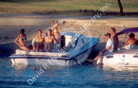 Scantily clad girls at spring break at Lake Havasu, Arizona chat with the boys.