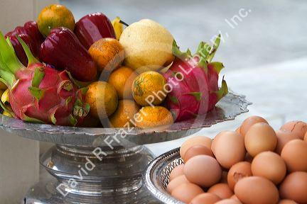 Fruit and egg offerings at the Temple of the Emerald Buddha located within the precincts of the Grand Palace, Bangkok, Thailand.