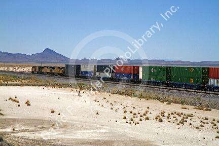 Union Pacific Railroad locomotive traveling along Interstate 10 through southwest New Mexico, USA.