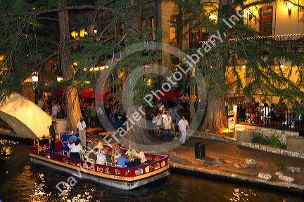 Boat guides tourists along the River Walk in San Antonio, Texas, USA.