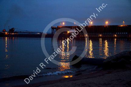 Great Lakes ore boat at dusk on Lake Superior at Marquette, Michigan, USA.