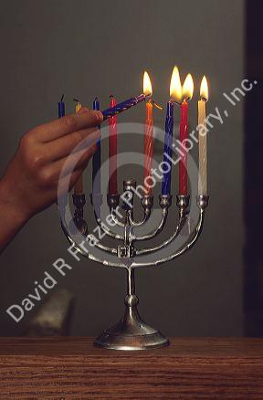A menorah being lit for haunika.