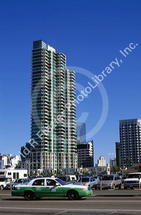 A taxi drives by highrise apartment condominiums in San Diego, California.