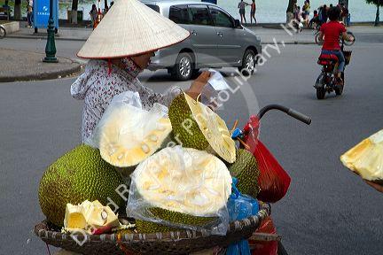 Vietnamese street vendor selling durian fruit in Hanoi, Vietnam.