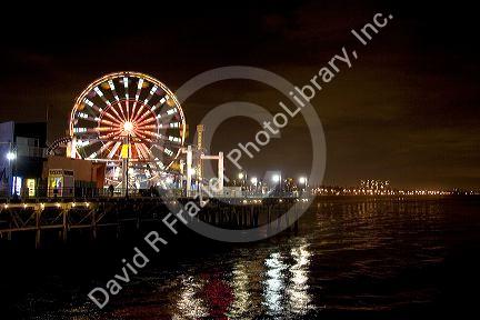 Ferris wheel and lights at night on the Santa Monica pier, California.
