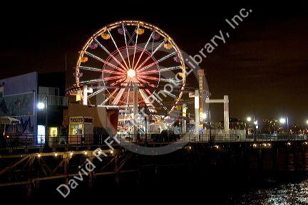 Ferris wheel and lights at night on the Santa Monica pier, California.