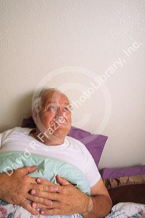An elderly man in bed with insomnia.