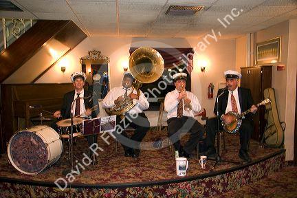 A Dixieland Jazz band plays aboard the Creole Queen riverboat in New Orleans, Louisiana.