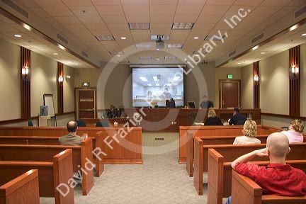 Video arraignment in criminal court in Boise, Idaho.  Defendants appear on video screen from secure jail facility while judge in courtroom conducts arraignment and sets bond.