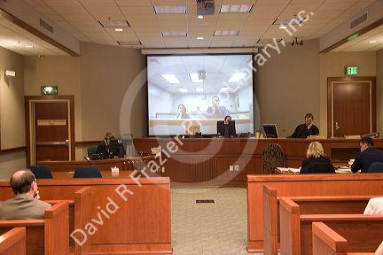 Video arraignment in criminal court in Boise, Idaho.  Defendants appear on video screen from secure jail facility while judge in courtroom conducts arraignment and sets bond.