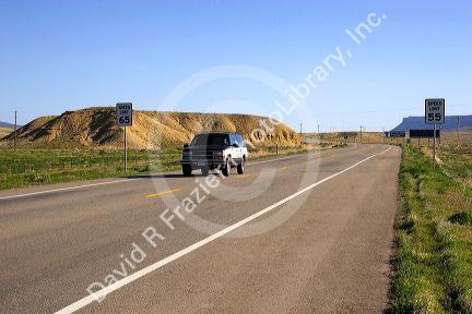 Road signs showing two different speed limits for the same US highway 491 at four corners south of Cortez, Colorado.