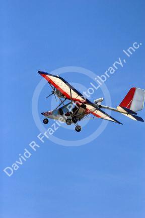 An ultralight aircraft flying in the sky.