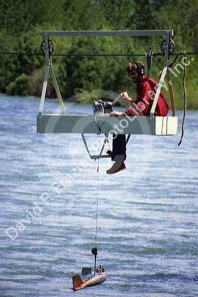 Hydrologist tests water quality and stream flow in the Boise River, Idaho.