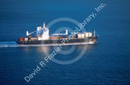 Self loading container ship heqading out to sea.
