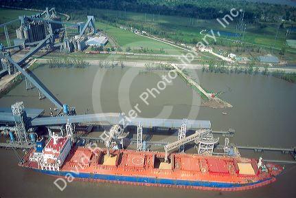 Bulk cargo ship takes on a load of grain on the Mississippi River near New Orleans, Louisiana.
