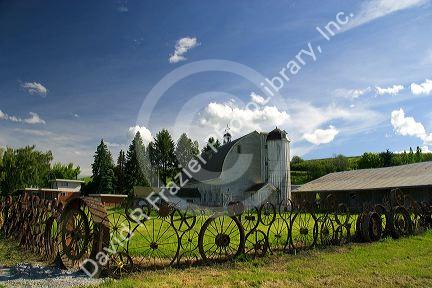 Farm in eastern Washington with old implement wheels fashioned into a fence.