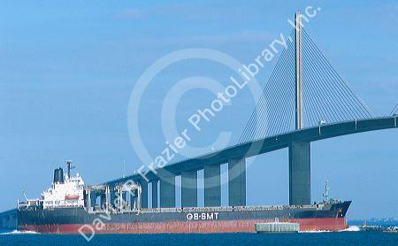 Ship passing under the Sunshine skyway suspension bridge over Tampa Bay, Florida.