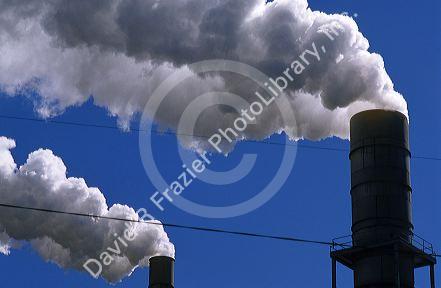 Smoke stacks emit air pollution at a manufacturing plant.