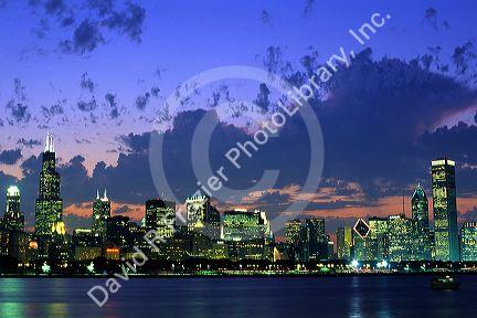 Chicago Illinois skyline at dusk with Lake Michigan in the foreground.