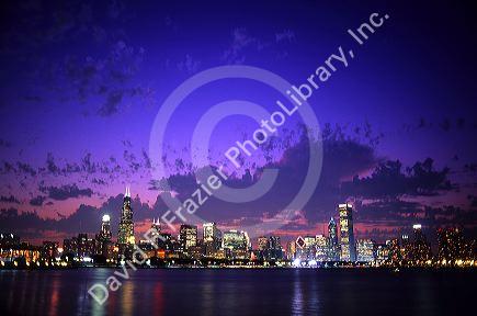 Chicago Illinois skyline at dusk with Lake Michigan in the foreground.